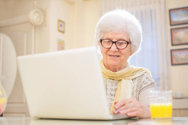 istock Senior woman using laptop at home. 808668722