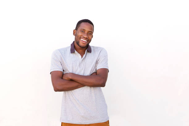 istock Smiling young african guy against a white wall 808669394