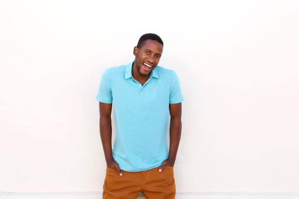 istock Handsome young african man laughing with hands in pocket 808669410