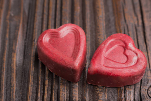istock Chocolate heart-shaped candy on wooden background 808679266