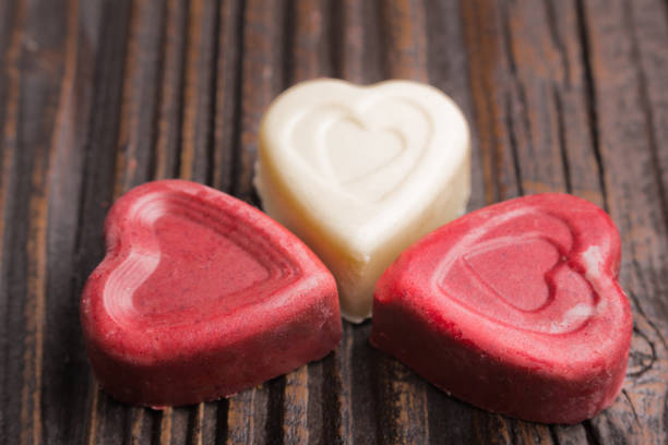istock Chocolate heart-shaped candy on wooden background 808680958