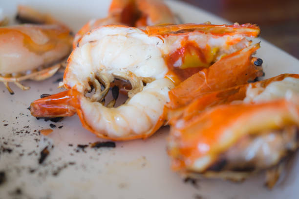 istock Close up cutting half shrimp burn sea food on dish 808690256