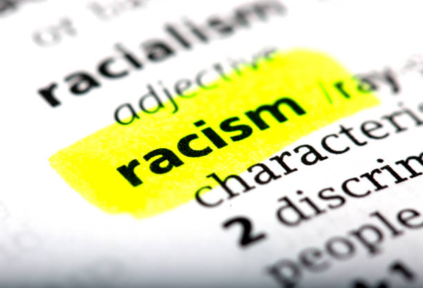 Racism is a word printed and highlighted in the English dictionary stock photo