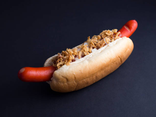istock Danish hot dog isolated on black background 808692572