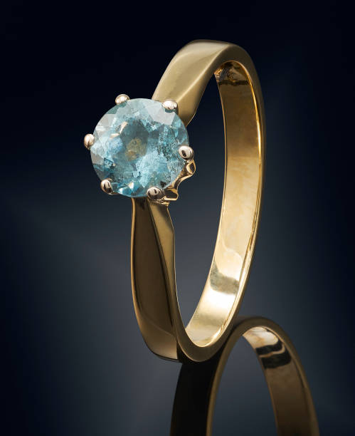 istock Golden ring with gemstone isolated on black background 808703240