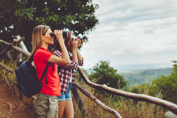 istock Two young women hiking and exploring the woods 808703864