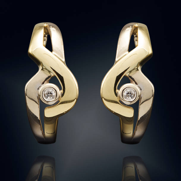 istock Golden earrings with gemstone isolated on black background 808704884