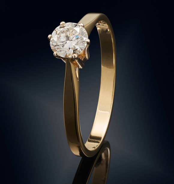 istock Golden ring with gemstone isolated on black background 808705156