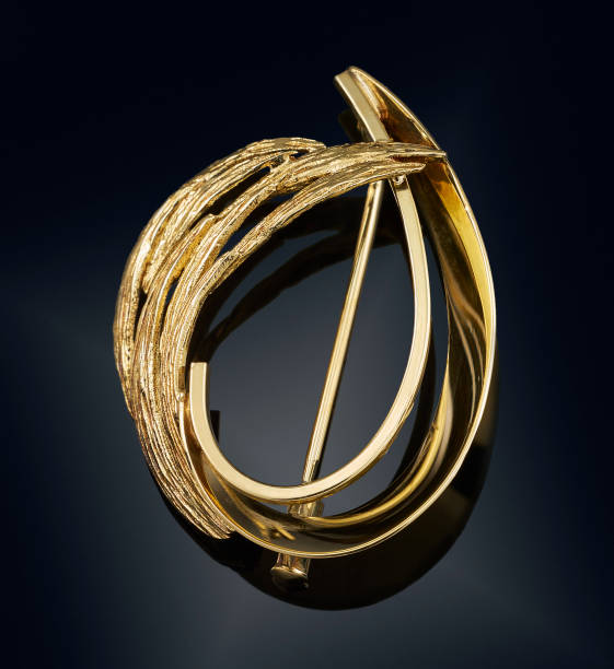 istock golden brooch isolated on black 808706878