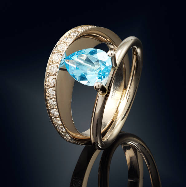 istock Golden ring with gemstone isolated on black background 808711000