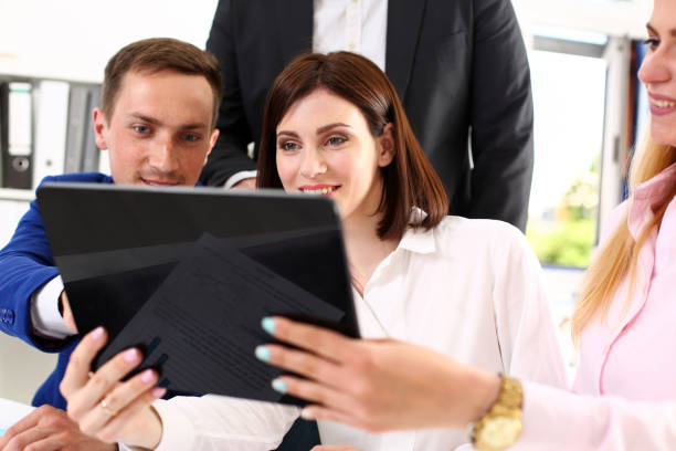 istock Group of people in office look at mobile tablet pc 808713446
