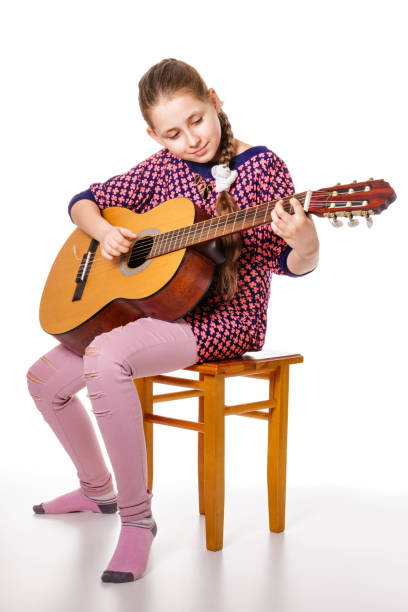 istock Girll teenager playing a guitar, isolated on a white background 808744416
