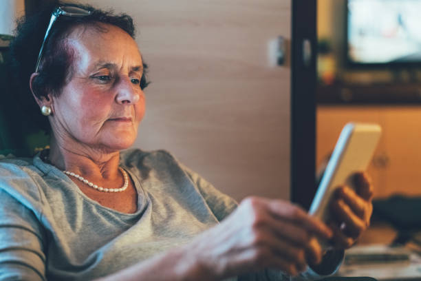 istock Senior woman at home using smartphone 808763346