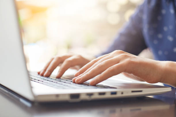 istock A shot of woman`s hands typing on keyboard while chatting with friends using computer laptop sitting at wooden table. People, lifestyle, modern technology and communication concept. 808764810