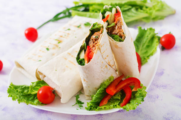 istock Burritos wraps with minced beef and vegetables on a light background. 808774018