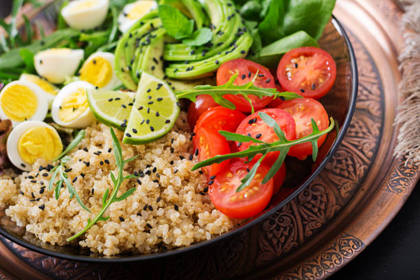 istock Diet menu. Healthy salad of fresh vegetables - tomatoes, avocado, arugula, egg, spinach and quinoa on a bowl 808778732
