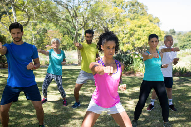 istock Group of people exercising in the park 808800340