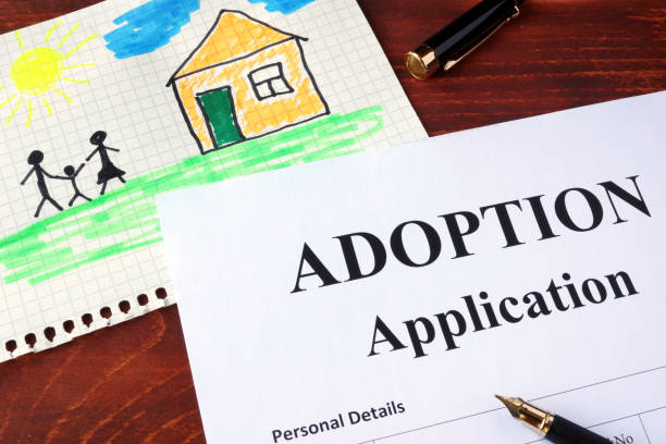 Adoption form and children’s picture. (I am owner of picture.) stock photo