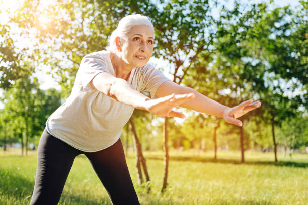 istock Positive senior woman doing sport exercises 808817824