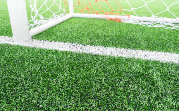 istock Soccer or Football artificial green grass field with empty player and sunset light for background. 808820938