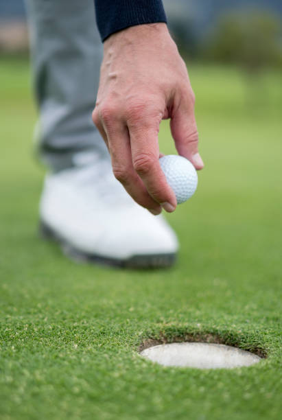 istock Man playing golf grabbing the ball 808828236
