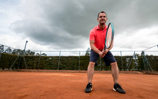 istock Man playing tennis at a clay court 808828378