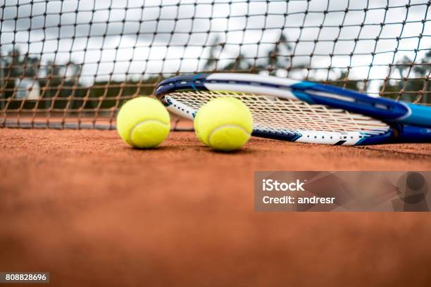 Tennis Racket And Balls At The Court Stock Photo - Download Image Now - Clay, Colombia, Exercising