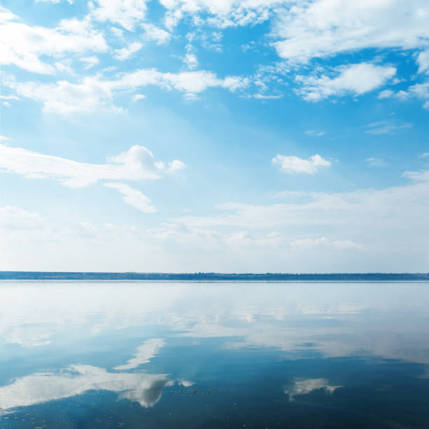 istock deep blue sky with clouds over river and reflection of it 808834950