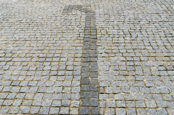 dark arrow to the left on a paved road