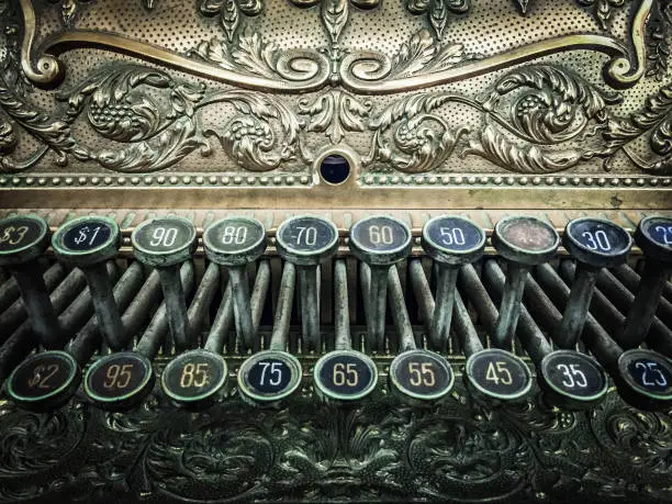 A close-up of the keys on an old cash register.