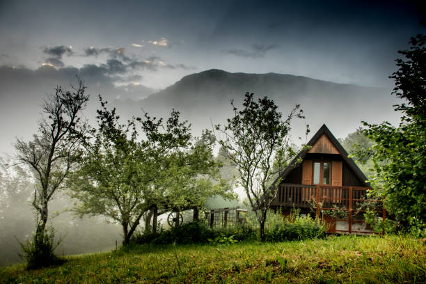 istock Clouds Taking Over A Mountain House At The Sunset 808908908