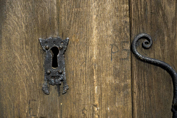istock Wrought Ironwork and keyhole old wooden door 808968338