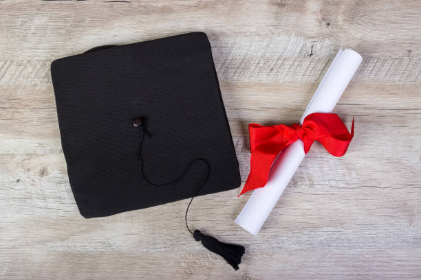 istock graduation cap, hat with degree paper on wood table graduation concept 808970430