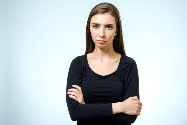 istock Beautiful young confident woman with serious expression isolated on gray 808982372