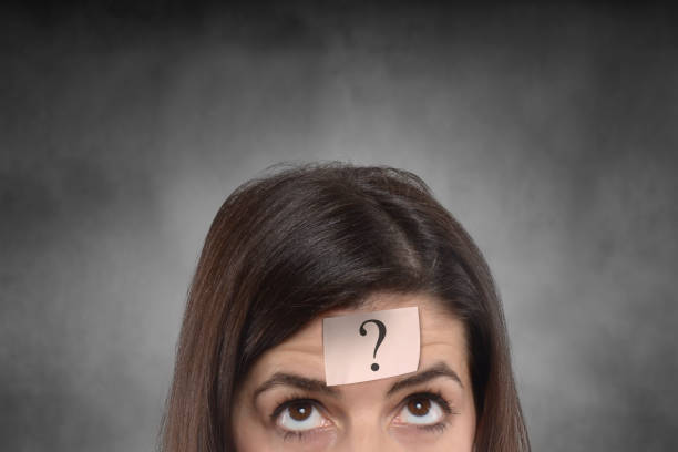 istock young woman with question mark on her forehead 809026086