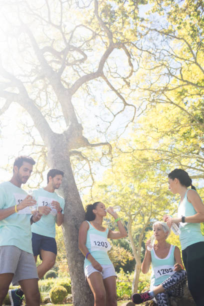 istock Marathon athletes having water in the park 809064178