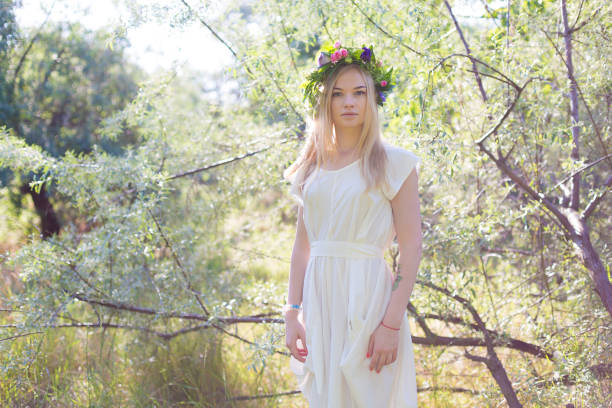 istock Beautiful young woman in flower wreath 809064236