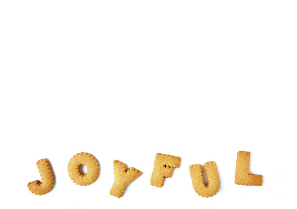 istock The word JOYFUL spelled with alphabet shaped biscuits, isolated on white background with free space for text and design 809072232
