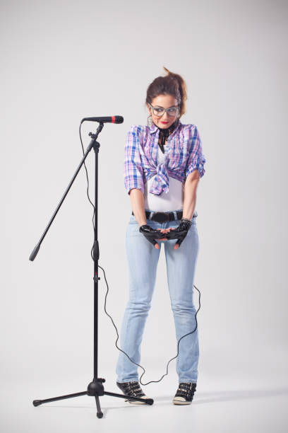 Funny nerdy female singer stock photo