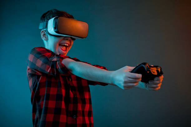 istock Excited boy playing gamepad in VR glasses 809092398