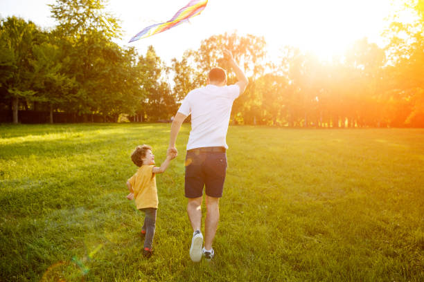 istock Father and sun holding hands running 809094796