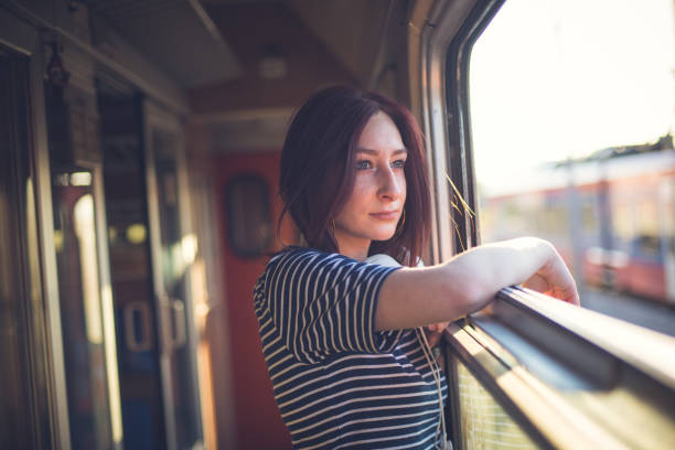 istock Female traveler in a  train  on a sunny summer day 809105476