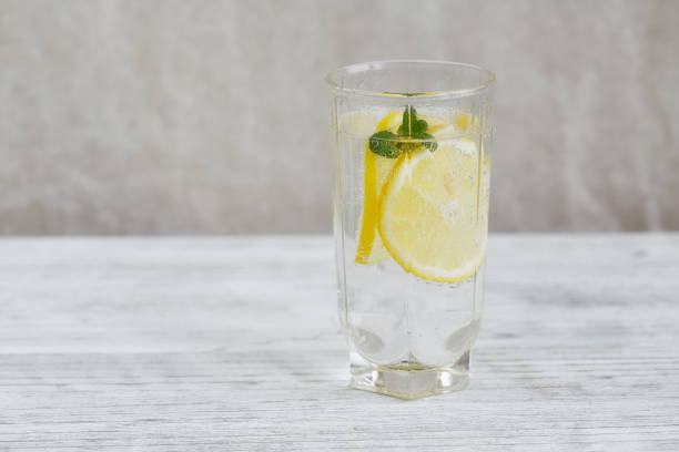 istock Lemonade with fresh lemon on wooden background 809106086