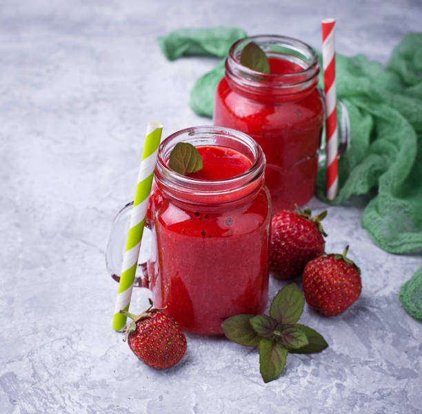 istock Strawberry smoothie in glass jars 809106114