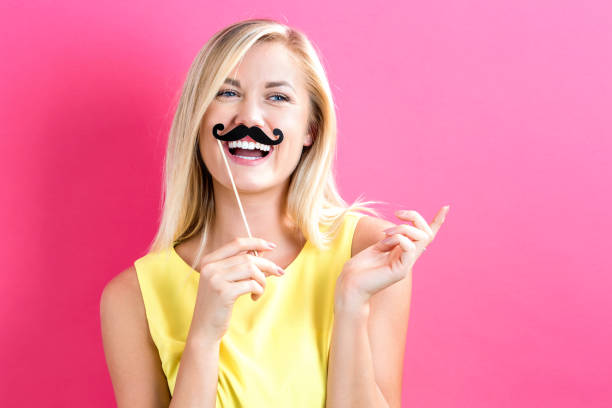 istock Young woman holding paper party sticks 809111528