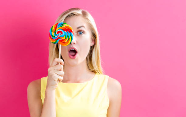istock Young woman holding a lollipop 809111566