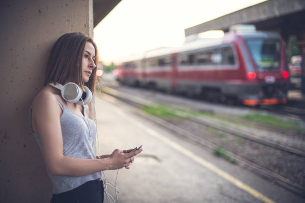istock Sad girl by the railroad 809125076