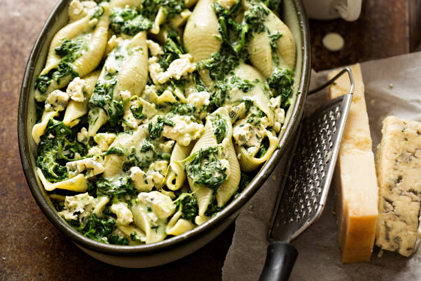 Spinach jumbo seashell pasta with parmesan and blue cheese oven ready bake stock photo