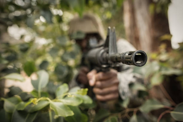 istock Military soldier guarding with a rifle 809150806