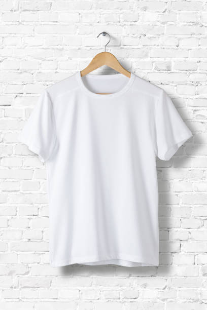 istock Blank White T-Shirt Mock-up hanging on white wall, front side view . Ready to replace your design 809171702